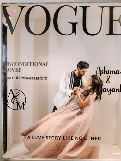 A fun and creative shot using a "Vogue" magazine cover prop. This is a great way to add a playful, high-fashion element to your engagement or pre-wedding shoot, creating a unique and memorable photo.