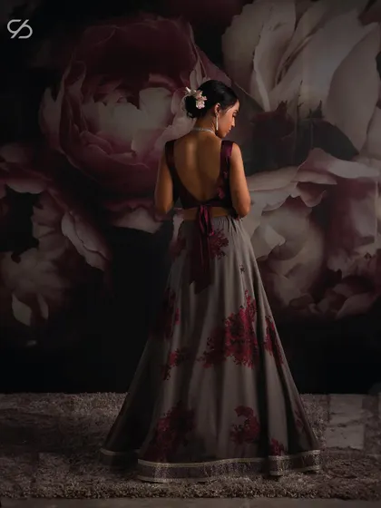 An essence of timeless, unapologetic style. The back of this grey and red floral lehenga showcases a modern silhouette, perfect for making a powerful statement.