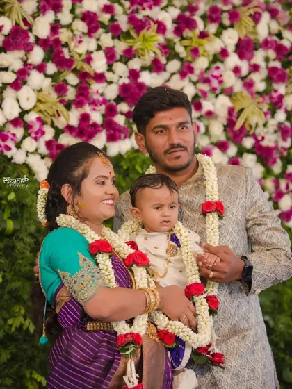 A beautiful family portrait from a naming ceremony. The mother's makeup is soft and pretty, designed to look wonderful in photos while she enjoys the special day with her family.