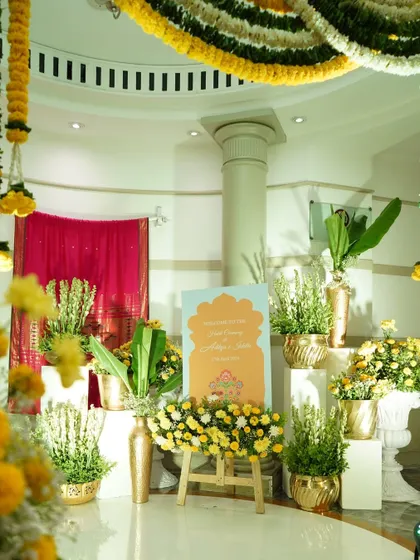 For this traditional Haldi ceremony, the welcome area is filled with marigolds and tuberoses in brass vases. The custom sign reflects the festive theme, creating an authentic and auspicious atmosphere.