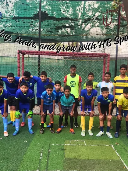 Play, train, and grow with HB Sports. Our entire football team stands with their coach, representing the unity and collective ambition of our academy.
