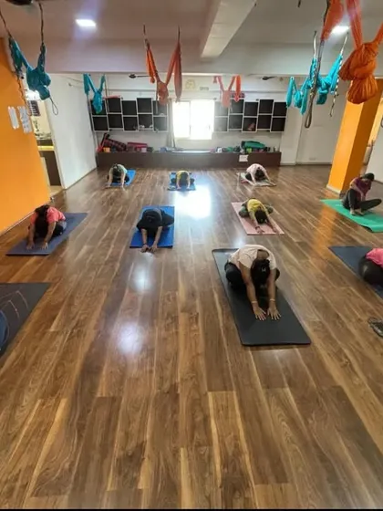 Awaken your inner warrior in our empowering group classes. These shots from our studio show students moving together, creating a powerful collective energy.