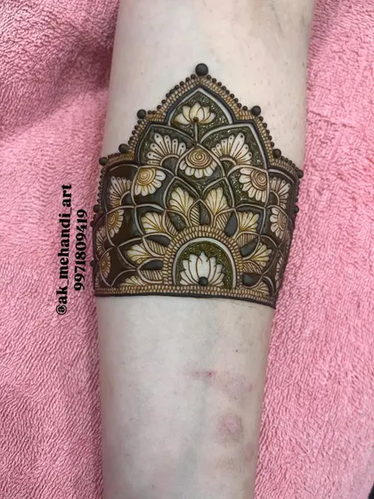 A beautiful cuff design featuring lotus motifs, created with fine lines and delicate shading.