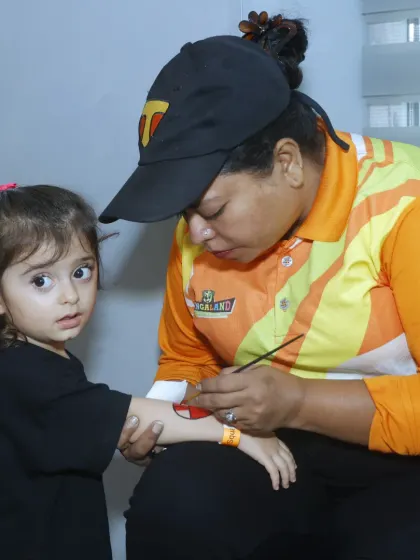 Our staff artist carefully applies a temporary tattoo to a young guest's arm. It's a fun and popular activity that makes kids feel special.