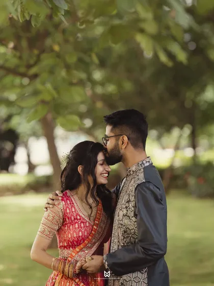 A tender forehead kiss during the Roka photoshoot. This classic pose is timeless and always conveys a sense of love and protection.