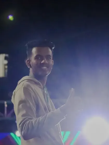 A happy moment captured on the DJ night stage, giving a thumbs-up to the camera.