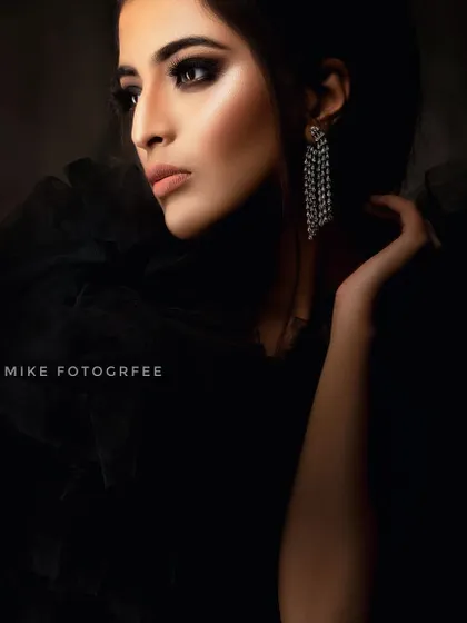 A moody, low-key portrait where the model's face is partially in shadow. This technique, known as chiaroscuro lighting, creates a dramatic and mysterious atmosphere.