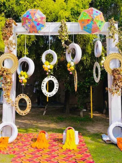 A quirky and creative photo booth for a Mehendi. I used painted tires, colorful umbrellas, and marigold garlands to create a unique and memorable backdrop.