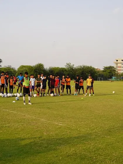 A coach addressing the team before starting a drill. Clear communication and instruction are central to our coaching.