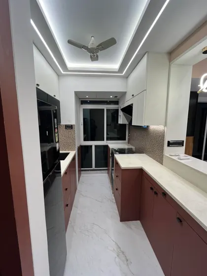 A slightly different angle of the modern kitchen, showing the clean lines and handle-less drawers. This design choice contributes to a sleek, uncluttered look that is easy to maintain.