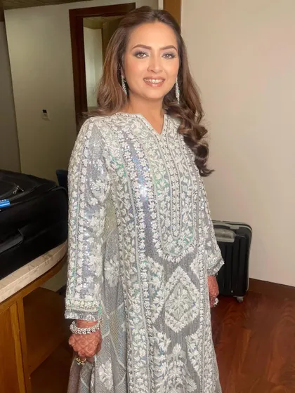 A stunning bronzed glam look for a Sangeet, featuring a smokey eye and beautifully highlighted skin.