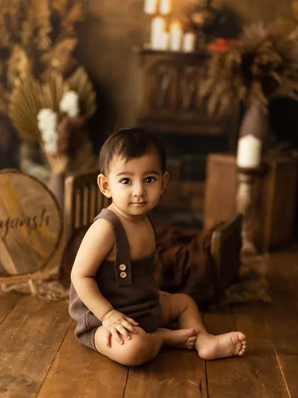 Another shot from the "Fun to be One" series, this portrait captures the little boy's sweet and serious side in a beautifully lit, rustic setting.
