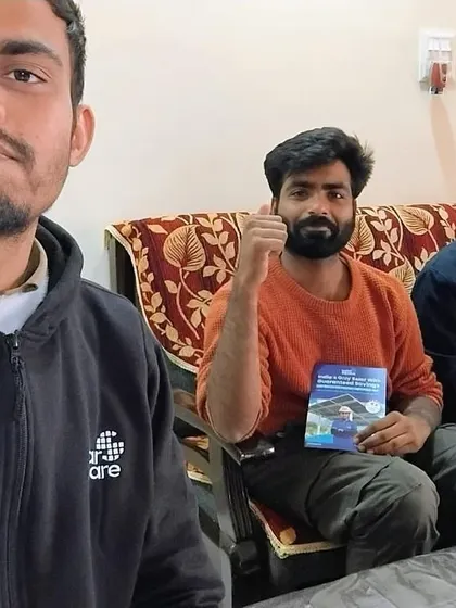 A selfie of our team member with a customer holding our solar guide. We are always happy to help.