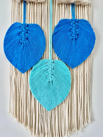 A close-up of the blue ombre leaves on the "Shrishti Saksham" name catcher.