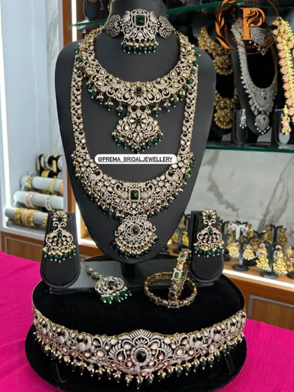 A full AD and emerald bridal combo, including a vaddanam and other accessories.