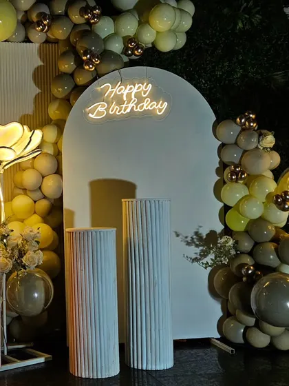 A close-up on the clean, modern aesthetic of the white arched panel and 'Happy Birthday' neon sign, perfect for a contemporary adult party.