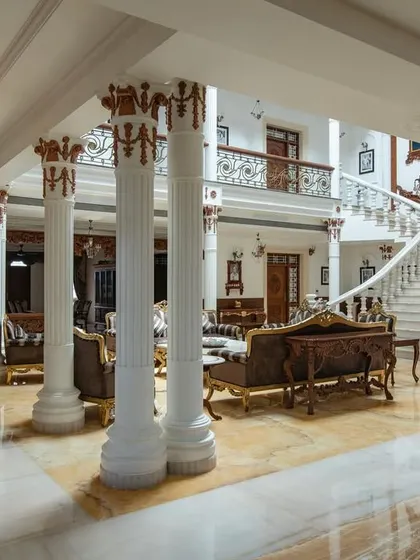 The view from the side of the living area, showing the intricate details on the columns and the seamless flow of the space.
