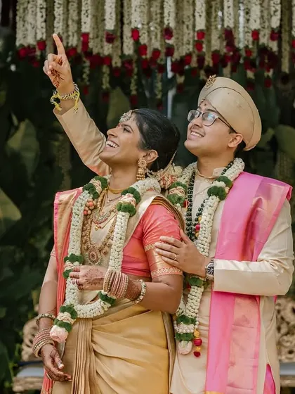 The couple looks up towards the sky, a candid moment of shared wonder during their wedding ceremony.
