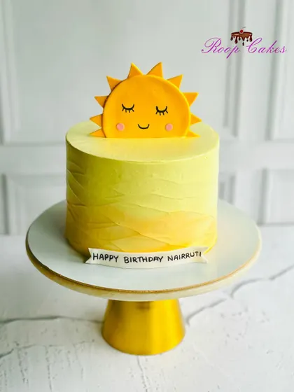 Hello Sunshine. A simple and cheerful cake with a cute smiling sun topper, perfect for brightening up any birthday.