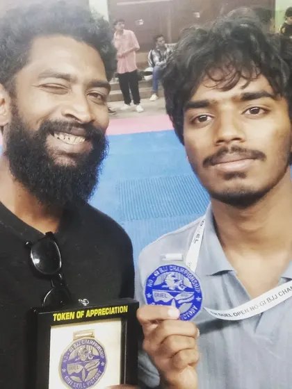 Posing with my student Dhanush after he secured a silver medal at the DUEL Grappling Championship. Even in a loss for gold, the experience from a hard fought match is invaluable.