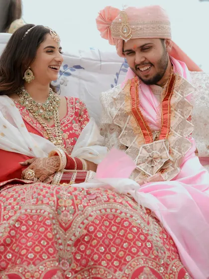 A candid moment of shared laughter between the couple during their wedding ceremony.
