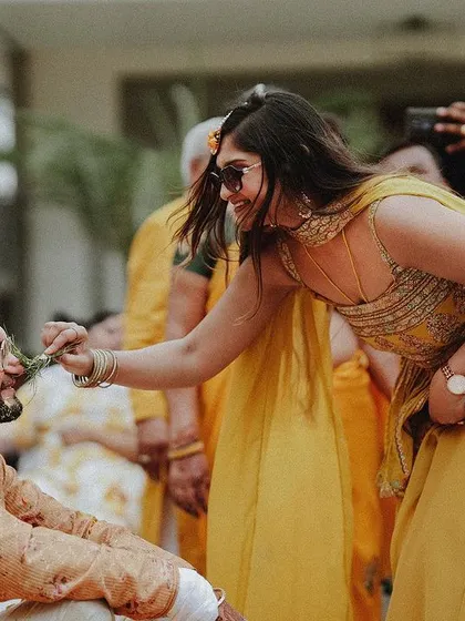 A duplicate of the sweet moment of the bride applying haldi to the groom.