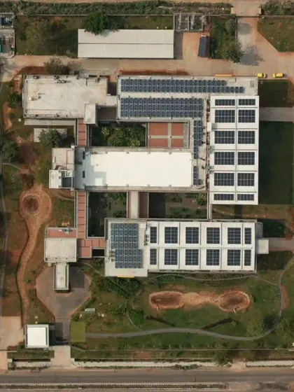 An aerial view of the Fanuc India factory, showing the extensive use of solar panels on the roof, a key part of its sustainable design.