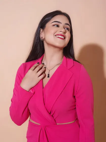A bright and happy shot. The hot pink dress is paired with a classic red lip and clean, defined eyes, creating a bold and confident look.