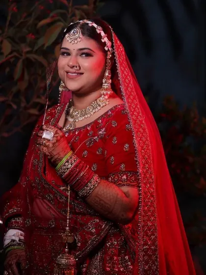 A full-length portrait of a bride in her magnificent red velvet lehenga. My course teaches you how to ensure the makeup looks balanced and beautiful from every angle, near or far.