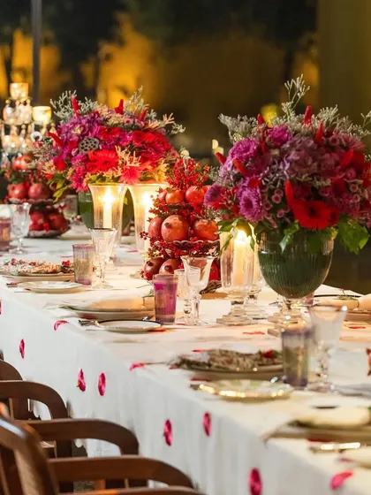 A tablescape should be a feast for the eyes. For this festive dinner, I used rich scarlet and burgundy tones, pomegranates, and glowing candles to create a warm, romantic, and luxurious atmosphere that invites guests to linger.