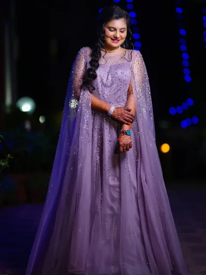 Another beautiful shot of the bride in her reception gown. Her gentle smile and the elegant drape of the cape create a fairytale-like image.
