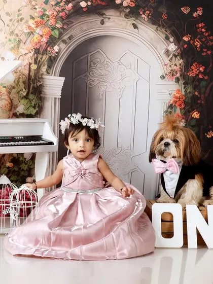 A girl and her best friend. This little one is celebrating her first birthday alongside her dapper-looking dog, making for an extra special memory.