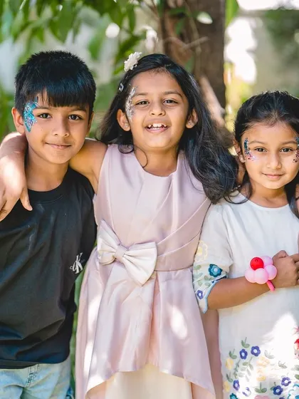 The joy of friendship and celebration. This candid shot of children at a birthday party, complete with face paint and smiles, captures the fun energy of the day.