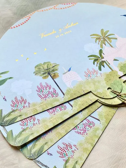 The back of the fan-shaped programs, featuring a beautiful illustration of the Arizona desert landscape with whimsical palace details.