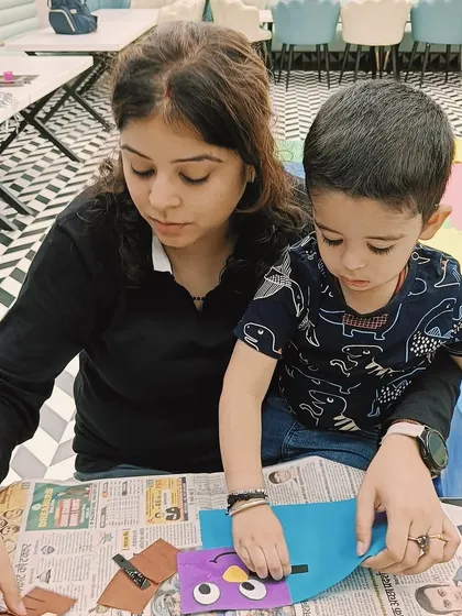 A mother and son are engrossed in their craft project, demonstrating the deep engagement our activities inspire.