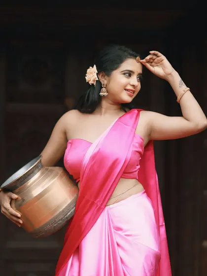 Another shot of the stunning pink satin saree, showcasing its beautiful drape and modern appeal.