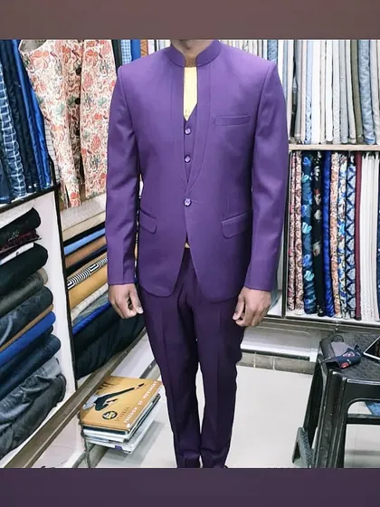 A bold purple three-piece Jodhpuri suit, tailored for a client in my shop. This shows how I can work with unique colors to create standout wedding outfits.