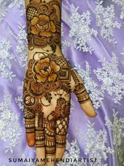 A beautiful floral henna design with large, detailed flowers.