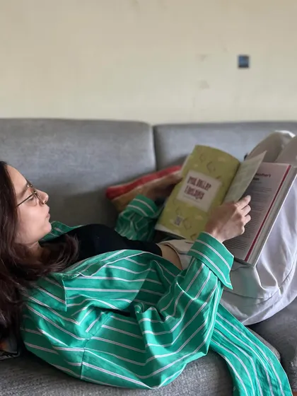 A cozy moment, reading 'Memories on a Plate' on the couch.