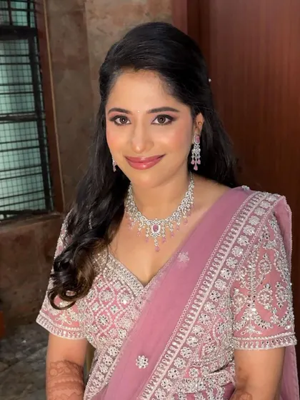 A beautiful portrait of Harshitha, showcasing her complete reception look. The makeup is glamorous yet feels light and comfortable.