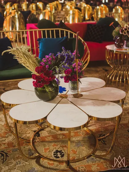 A unique flower-shaped center table, with each 'petal' holding a small floral arrangement, creating a stunning and functional art piece.