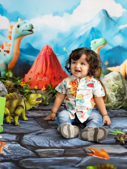 A big, happy smile from our little explorer in Jurassic world. His dinosaur-print shirt perfectly matches the theme.