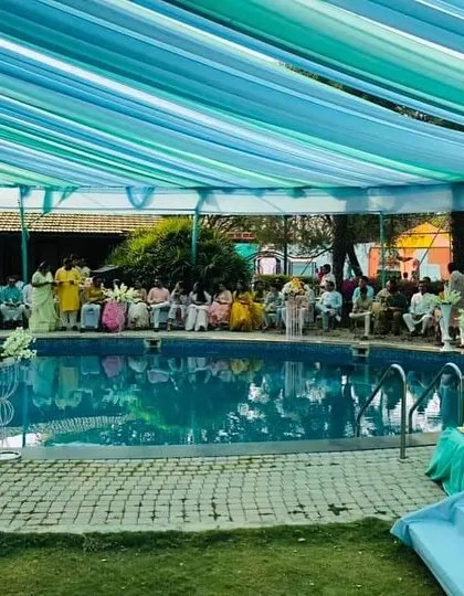 A view of the guests enjoying the poolside Haldi ceremony. This shows how the decor creates a beautiful environment for the celebration.