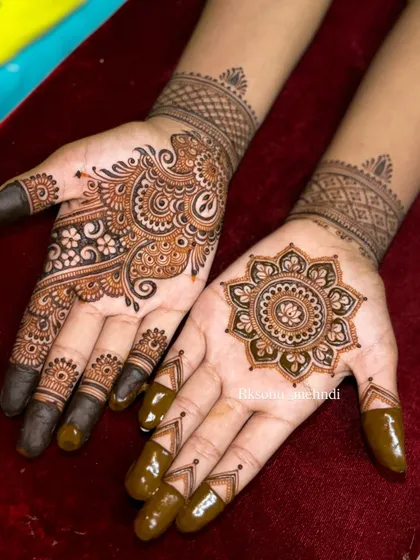 This is a beautiful example of an asymmetrical design. One hand features a classic mandala, while the other is adorned with a flowing paisley pattern, creating a balanced yet modern look.