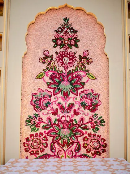 The complete floral mosaic arch, a testament to the hours of craftsmanship that go into creating such a unique and personalized wedding element.
