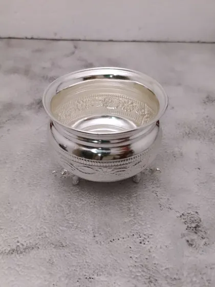 A simple and elegant German silver bowl with three small legs, perfect for holding offerings.