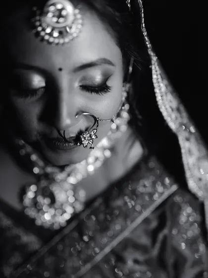 A timeless black and white portrait of a Marwadi bride. This classic style emphasizes the intricate details of her jewelry and the emotion in her expression.