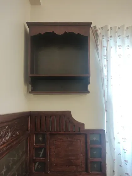 The wall-mounted pooja shelf and a section of the custom headboard, illustrating how we blend functional and spiritual elements into a cohesive design.
