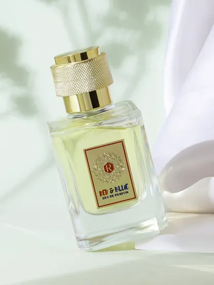 A fresh and airy composition for a perfume, using a white fabric backdrop and subtle shadows from leaves. This styling gives the product a natural and light feeling, perfect for a daytime fragrance.