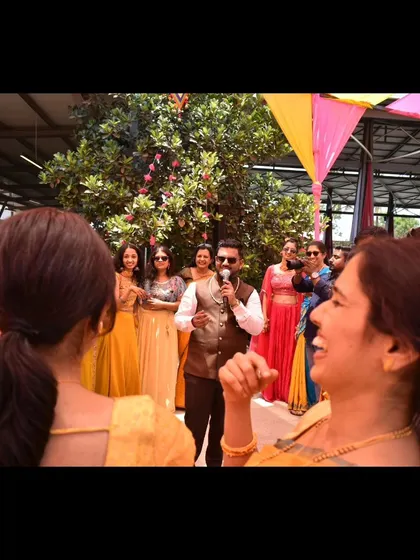 A candid moment of laughter with the guests during a Haldi event.